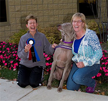 Dog Trainer Margaret Simek with happy client and their dog.